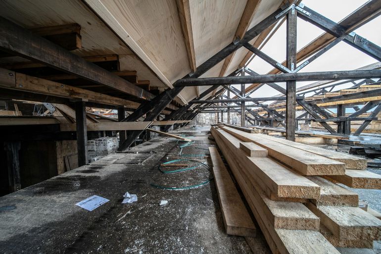 Деревянные балки строящегося каркаса с открытыми стойками и обрешёткой