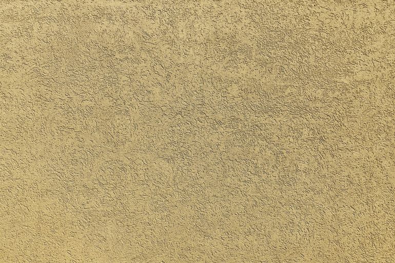 Однородная текстура свежей штукатурки на стене с мелким зерном поверхности